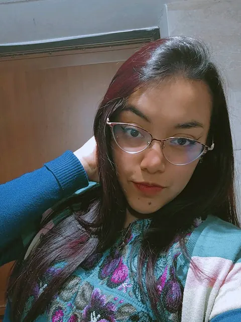 Woman with glasses and a patterned top